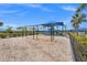 Playground features swings, a slide, climbing structure and seating under a canopy at 6295 Crested Eagle Ln, Nokomis, FL 34275