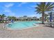 Beautiful resort-style pool surrounded by palm trees, lounge chairs, and manicured landscaping at 6295 Crested Eagle Ln, Nokomis, FL 34275