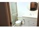 Well-lit bathroom featuring a shower, toilet, vanity with sink and white cabinets at 6462 Wild Oak Bay Blvd # 245, Bradenton, FL 34210
