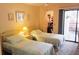 Cozy bedroom with twin beds, access to a patio and a walk-in closet at 6462 Wild Oak Bay Blvd # 245, Bradenton, FL 34210