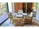 Bright dining area featuring a glass table, cushioned chairs and view of green outdoors at 6462 Wild Oak Bay Blvd # 245, Bradenton, FL 34210