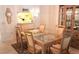 Elegant dining room with glass table, chairs, and display cabinet at 6462 Wild Oak Bay Blvd # 245, Bradenton, FL 34210