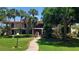 Charming condo building with lush landscaping, red roof, manicured lawn and a brick walkway at 6462 Wild Oak Bay Blvd # 245, Bradenton, FL 34210