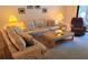 Cozy living room featuring comfortable floral sofas, accent lamps, and a neutral color palette at 6462 Wild Oak Bay Blvd # 245, Bradenton, FL 34210