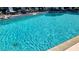 Beautiful community pool with lounge chairs and tables for relaxing in the sun at 6462 Wild Oak Bay Blvd # 245, Bradenton, FL 34210