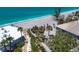 Stunning aerial view of a coastal home with a white roof near a beautiful turquoise beach at 7985 Manasota Key Rd, Englewood, FL 34223