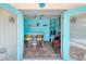 Bright blue wet bar with tile floor, counter with stools, and exterior access at 7985 Manasota Key Rd, Englewood, FL 34223