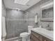 Bathroom features a glass enclosed shower, tiled walls, and modern vanity with under cabinet storage at 7985 Manasota Key Rd, Englewood, FL 34223