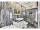 Well-lit bathroom with vanity, tiled walls, and a glass-enclosed shower at 7985 Manasota Key Rd, Englewood, FL 34223