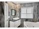 Modern bathroom with a soaking tub, vanity, and tiled walls at 7985 Manasota Key Rd, Englewood, FL 34223