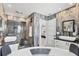 A luxurious bathroom featuring dual sinks, a soaking tub, a walk-in shower and gray marble style tile at 7985 Manasota Key Rd, Englewood, FL 34223