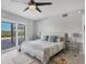 Bright bedroom with a large sliding glass door to an outdoor balcony with water view at 7985 Manasota Key Rd, Englewood, FL 34223
