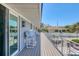 Spacious outdoor deck with seating area overlooking a serene neighborhood at 7985 Manasota Key Rd, Englewood, FL 34223