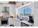 Modern kitchen features granite countertops, stainless appliances, and a view of the water at 7985 Manasota Key Rd, Englewood, FL 34223