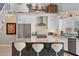 Bright and airy kitchen with stainless steel appliances, a center island, and a built-in range hood at 7985 Manasota Key Rd, Englewood, FL 34223