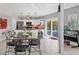 Dining room area showcasing the kitchen with stainless steel appliances and breakfast bar seating at 7985 Manasota Key Rd, Englewood, FL 34223