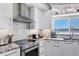 Well-lit kitchen with stainless appliances, granite counters and backsplash, and a great view of the water at 7985 Manasota Key Rd, Englewood, FL 34223
