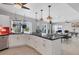 Bright kitchen with white cabinets, dark countertops, and views of the dining area and waterfront at 7985 Manasota Key Rd, Englewood, FL 34223