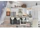 Modern kitchen with stainless steel appliances, a kitchen island with bar seating, and lots of natural light at 7985 Manasota Key Rd, Englewood, FL 34223