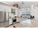 Bright modern kitchen with stainless appliances, granite countertops, and a view of the water at 7985 Manasota Key Rd, Englewood, FL 34223