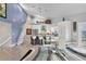 Bright, open kitchen with stainless steel appliances, a large island, and adjacent dining area beneath soaring ceilings at 7985 Manasota Key Rd, Englewood, FL 34223