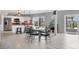 Open kitchen and dining area with modern appliances, dining table, and sliding glass doors at 7985 Manasota Key Rd, Englewood, FL 34223