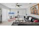 Spacious living room with tile flooring, modern furniture, and natural light from windows at 7985 Manasota Key Rd, Englewood, FL 34223