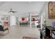 Open-concept living room featuring tile floors, ceiling fan, and view of the kitchen and dining areas at 7985 Manasota Key Rd, Englewood, FL 34223