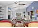 Open living room featuring a stone fireplace, comfortable seating, and panoramic water views at 7985 Manasota Key Rd, Englewood, FL 34223