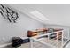 Bright loft area with an office setup beneath a skylight at 7985 Manasota Key Rd, Englewood, FL 34223