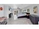 Large main bedroom with balcony access, a flat-screen television, and dark wood furniture at 7985 Manasota Key Rd, Englewood, FL 34223