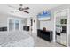 Spacious main bedroom featuring balcony access and a large flat-screen television at 7985 Manasota Key Rd, Englewood, FL 34223