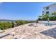 Waterfront patio with fire pit, picnic table, palm trees and small bridge at 7985 Manasota Key Rd, Englewood, FL 34223