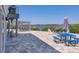 Spacious outdoor brick patio with waterfront view, pergola, outdoor bar, and picnic table at 7985 Manasota Key Rd, Englewood, FL 34223