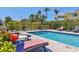Inviting backyard pool area surrounded by black iron fencing, tropical foliage, and patio furniture at 7985 Manasota Key Rd, Englewood, FL 34223