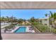 Inviting pool area view from the deck with tropical landscaping at 7985 Manasota Key Rd, Englewood, FL 34223