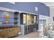 Elegant wet bar with granite countertops, modern fixtures, and built-in wine storage at 7985 Manasota Key Rd, Englewood, FL 34223