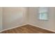 Bedroom features neutral walls and hardwood floors with one window and a ceiling fan at 8019 Indigo Ridge Ter, Bradenton, FL 34201