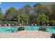 Resort-style pool with lounge chairs and lush tropical landscaping at 8019 Indigo Ridge Ter, Bradenton, FL 34201