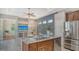 Stylish kitchen featuring stainless steel appliances, granite countertops, wood cabinets, and an open layout at 8019 Indigo Ridge Ter, Bradenton, FL 34201