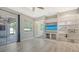 Bright living room featuring a built-in entertainment center and sliding glass doors to the outdoor space at 8019 Indigo Ridge Ter, Bradenton, FL 34201
