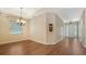 Open floor plan featuring elegant hardwood floors, chandelier, and lots of natural light at 8019 Indigo Ridge Ter, Bradenton, FL 34201