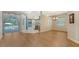 Bright open space with wood floors and sliding glass doors leading to the lanai and pool at 8019 Indigo Ridge Ter, Bradenton, FL 34201