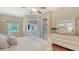 Bright main bedroom features neutral walls, hardwood floor, slider to patio and a ceiling fan at 8019 Indigo Ridge Ter, Bradenton, FL 34201