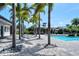 Community pool with shaded seating and palm trees around the border at 8019 Indigo Ridge Ter, Bradenton, FL 34201
