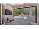 Screened-in lanai with view of the pool, water feature, and outdoor furniture at 8019 Indigo Ridge Ter, Bradenton, FL 34201