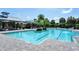 Community pool with crystal clear blue water, palm trees, lounge area and bathhouse at 8019 Indigo Ridge Ter, Bradenton, FL 34201
