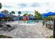 Community pool featuring lounge chairs, bath house, playground and table with chairs at 8019 Indigo Ridge Ter, Bradenton, FL 34201