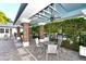 Charming poolside lounge area with an open ceiling, tables, chairs and brick pillars at 8019 Indigo Ridge Ter, Bradenton, FL 34201