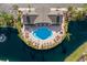 Aerial view of the community pool, bordered by tropical landscaping and blue waters at 8045 Tybee Ct # 8045, University Park, FL 34201
